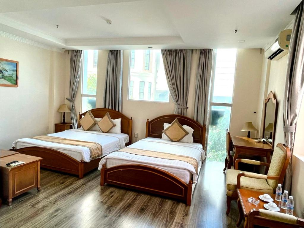 Postel nebo postele na pokoji v ubytování Madella Hotel