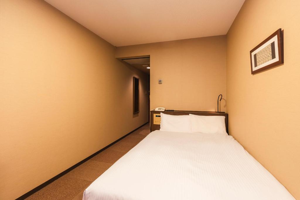 Postel nebo postele na pokoji v ubytování Hotel Sunroute Niigata