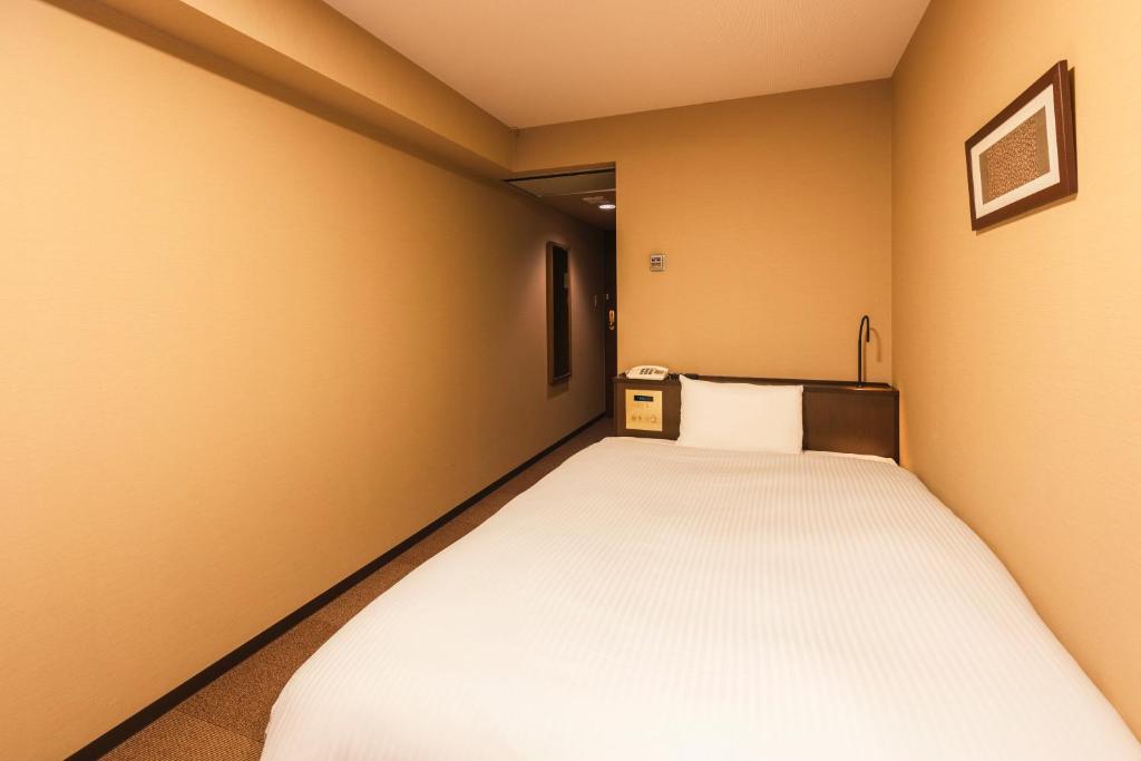 Postel nebo postele na pokoji v ubytování Hotel Sunroute Niigata
