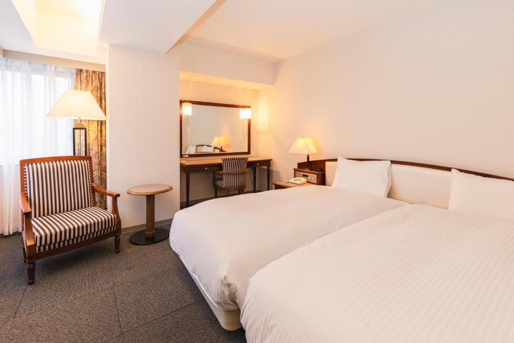 Postel nebo postele na pokoji v ubytování Hotel Sunroute Niigata