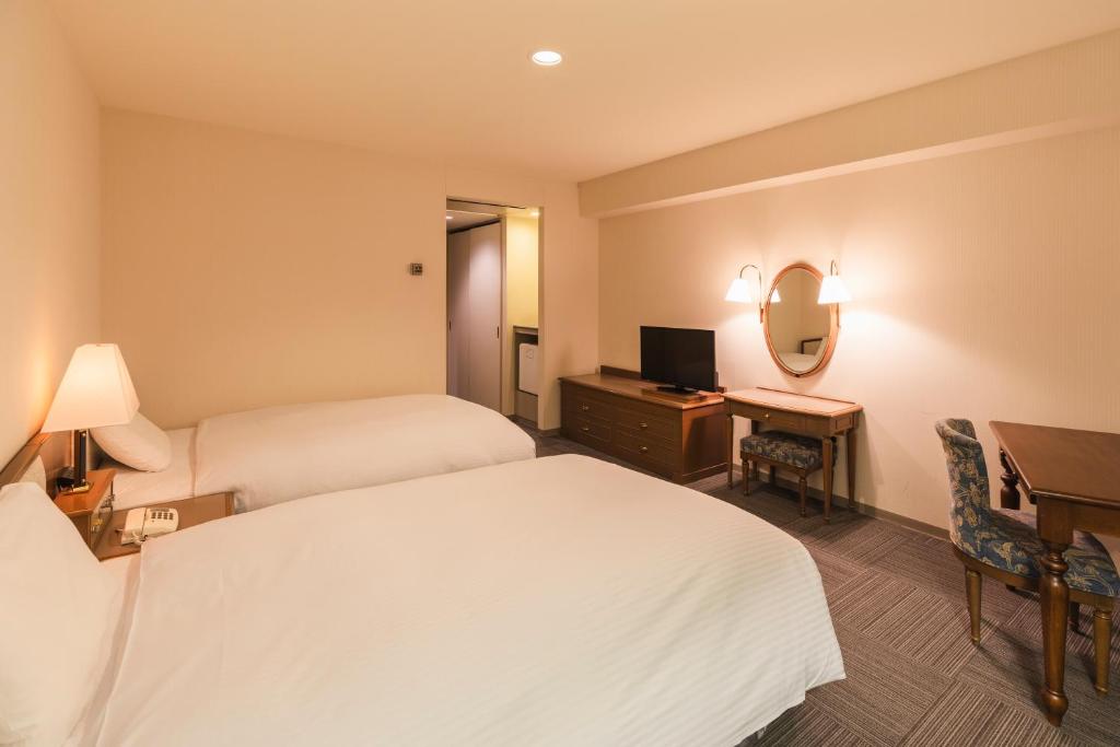 Postel nebo postele na pokoji v ubytování Hotel Sunroute Niigata