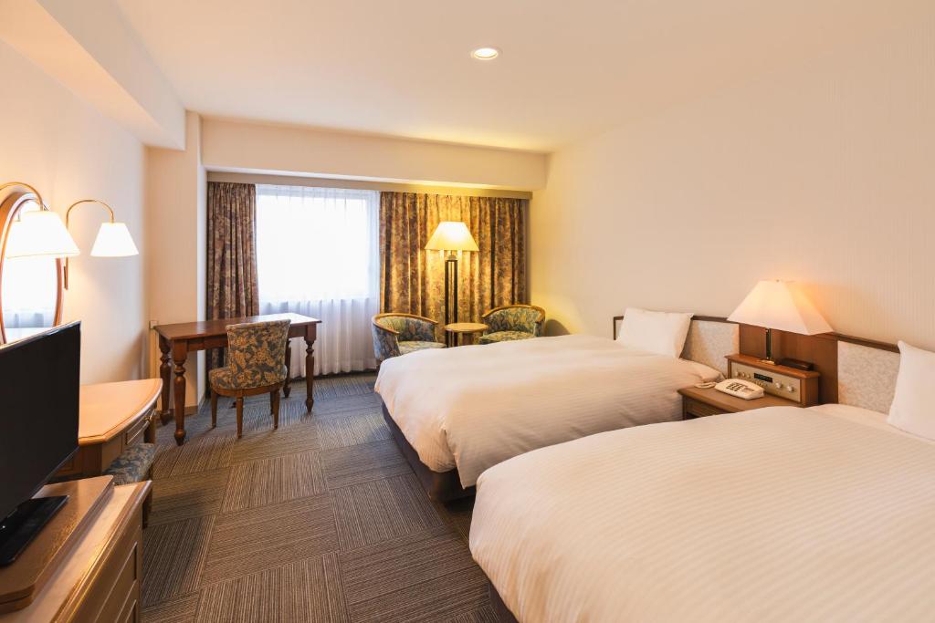 Postel nebo postele na pokoji v ubytování Hotel Sunroute Niigata