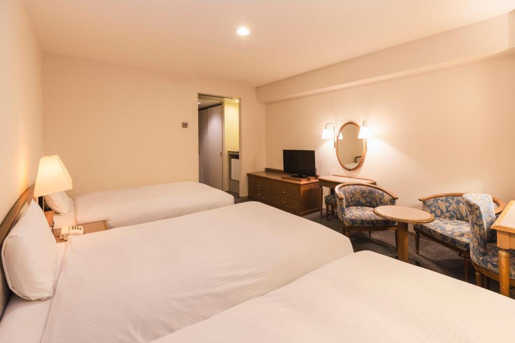 Postel nebo postele na pokoji v ubytování Hotel Sunroute Niigata