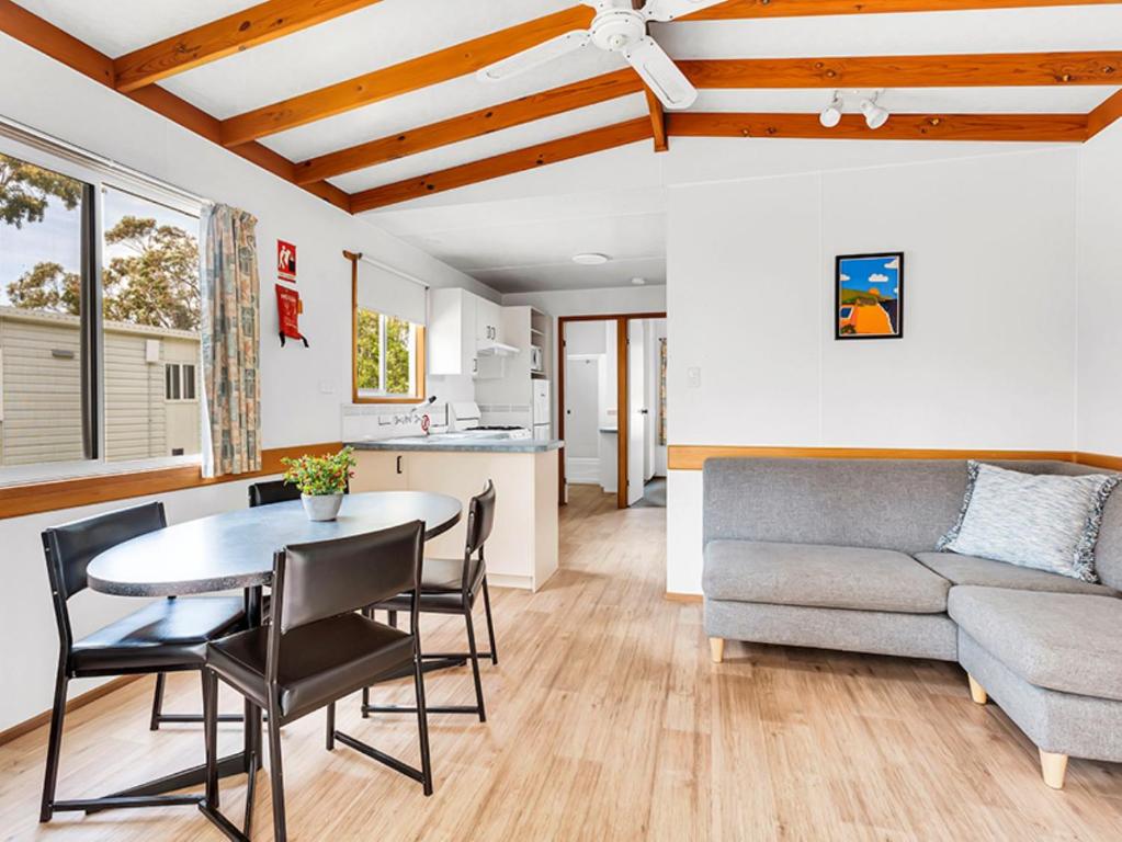 a living room with a table and a couch at Ingenia Holidays Torquay Australia in Torquay