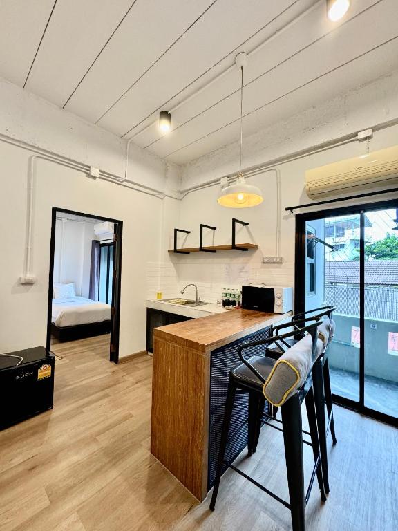 A compact kitchen and dining counter beside a glass door.
