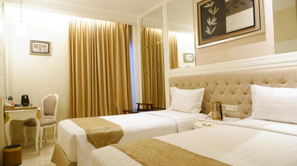 Postel nebo postele na pokoji v ubytování Grand Savero Hotel Bogor