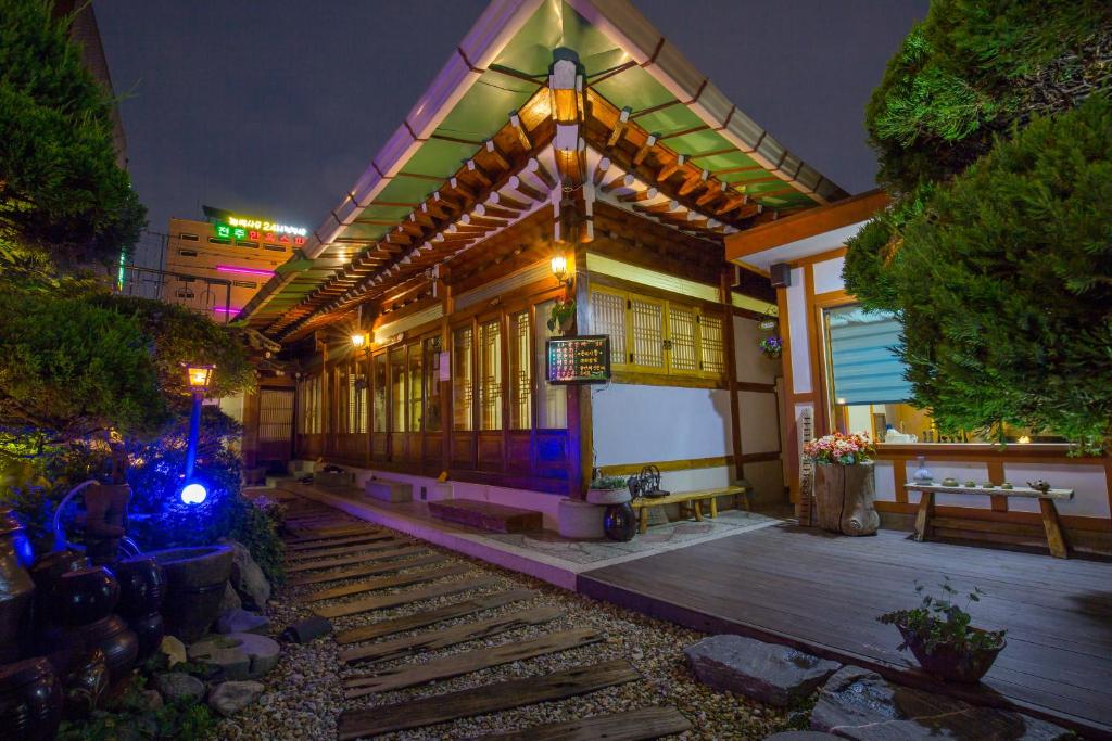 a house with a lit up front of it at night at Ddlanchae Hanok Stay - Main House in Jeonju
