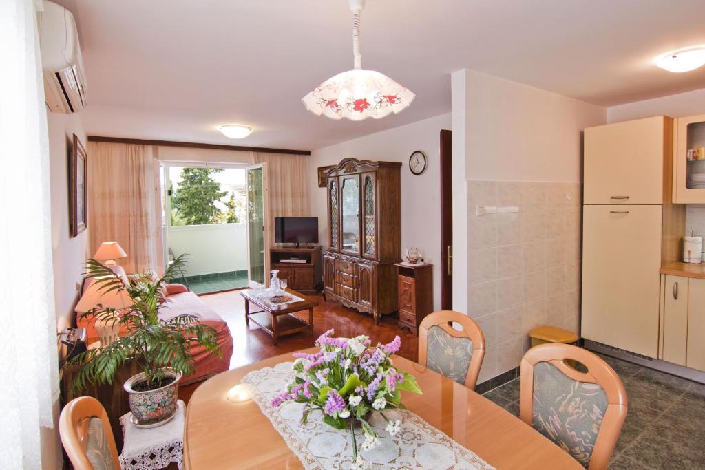 a dining room and living room with a table at Apartment Tennis in Split