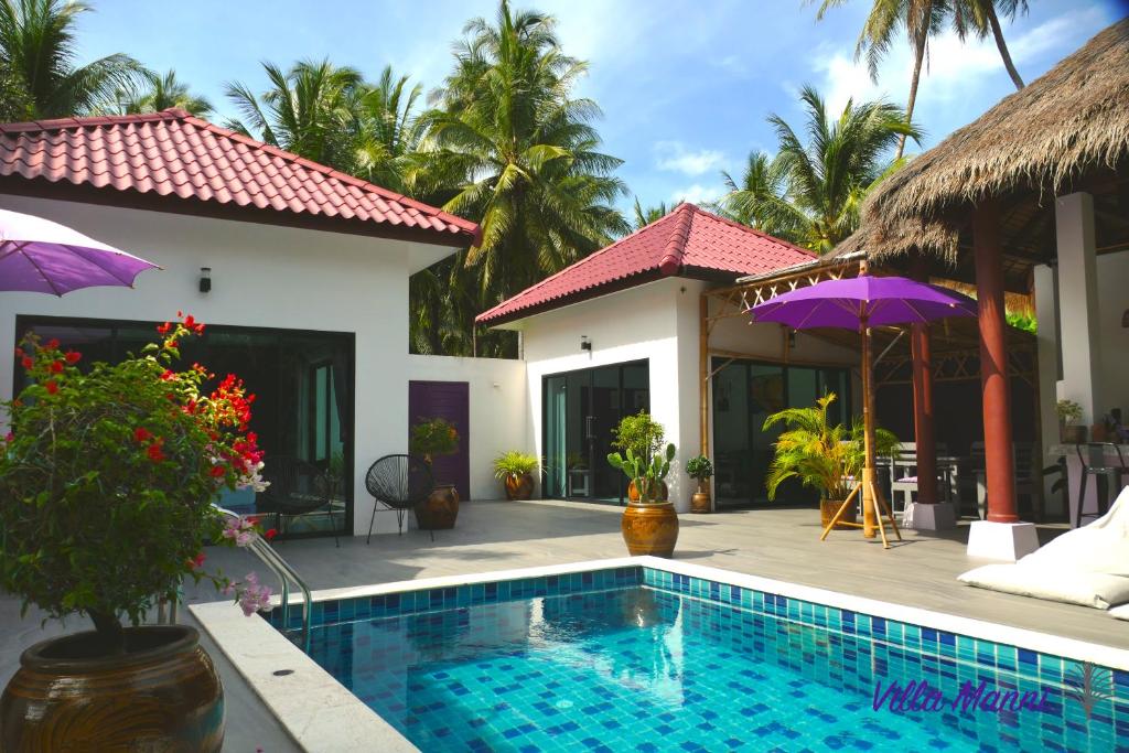 a villa with a swimming pool and a house at Villa Manni Koh Phangan in Koh Phangan