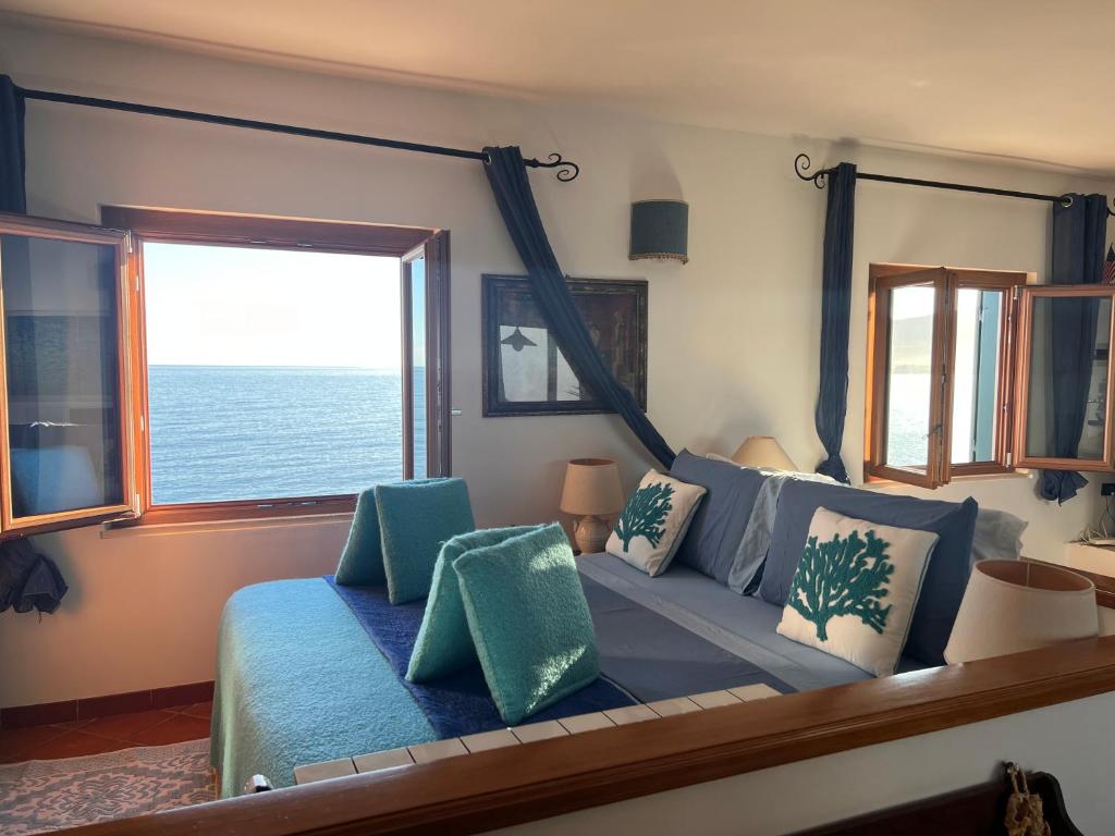 a living room with a couch and a large window at Attico Vista Mare Trapani in Trapani