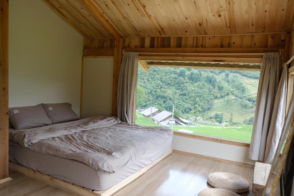 Postel nebo postele na pokoji v ubytování DE MONG SAPA