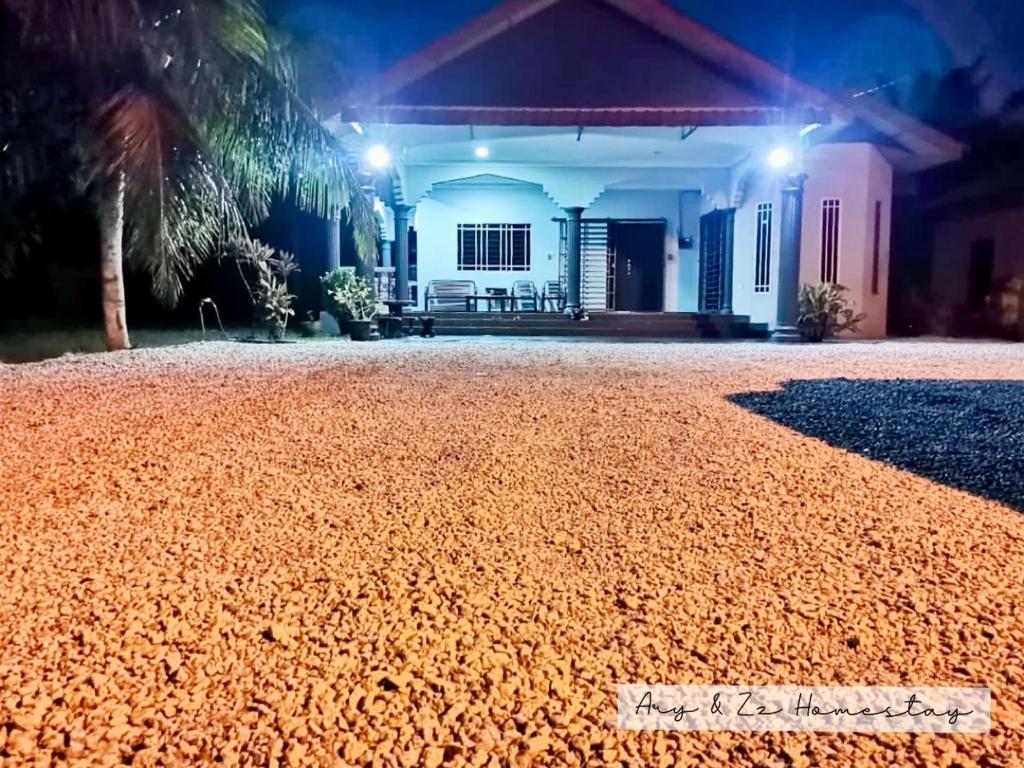 a house with a gravel driveway at night at ARY&ZZ Homestay for islam guests in Tanjung Karang
