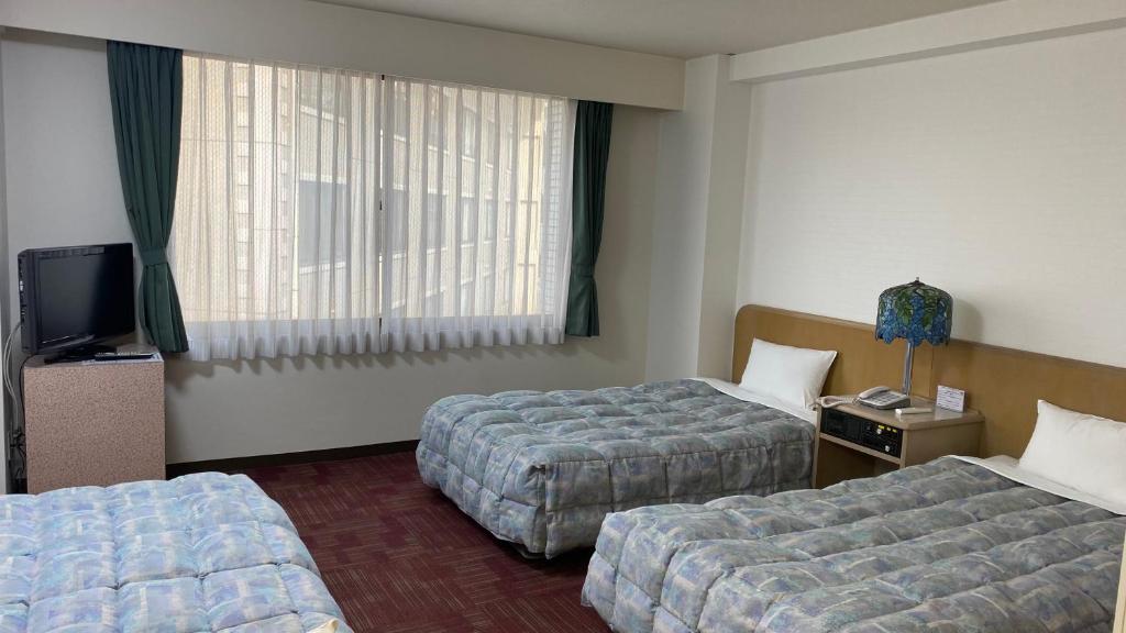 Postel nebo postele na pokoji v ubytování Hotel Luna Park