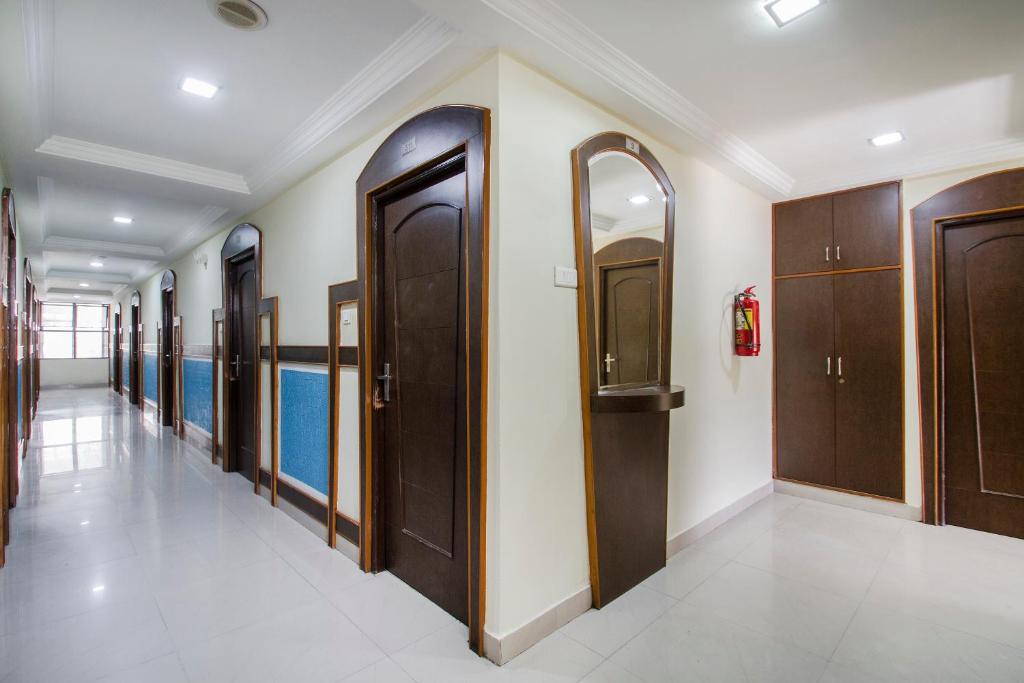 a hallway with wooden doors and a swimming pool at Super OYO Flagship Hotel Surya Residency in Ameerpet