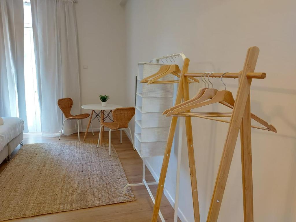 a room with a bed and a ladder with a table at Zuzu Studio apartments in Tel Aviv
