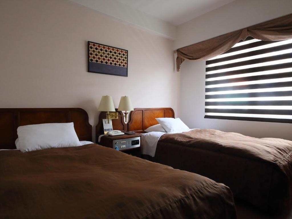 Postel nebo postele na pokoji v ubytování Hotel Claiton Shin-Osaka
