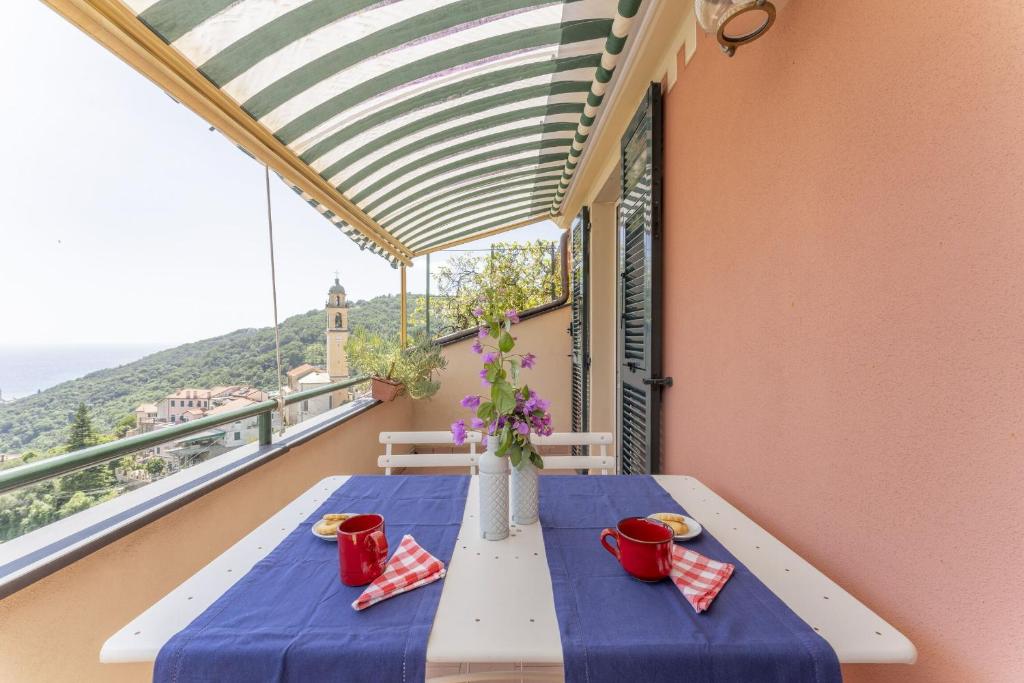 a table on a balcony with a view at Emma House Terrace and Sea View Moneglia in Moneglia
