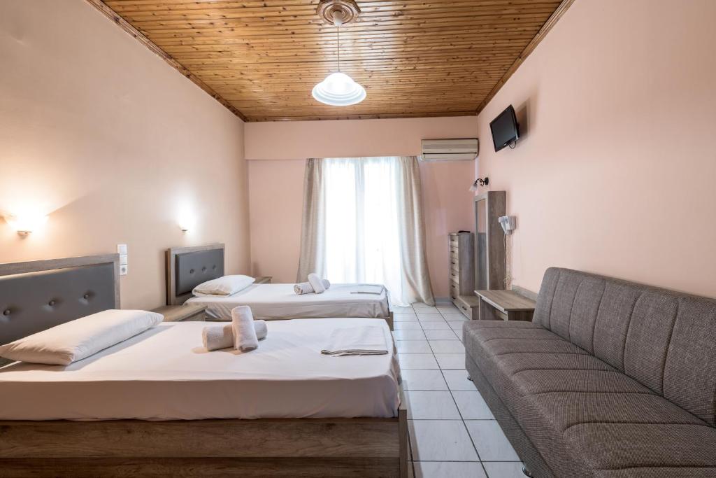 Postel nebo postele na pokoji v ubytování APHRODITE APARTMENTS