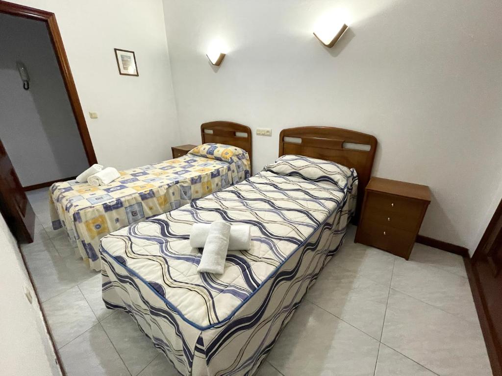 A bed or beds in a room at Apartamentos Revo Salinas 3000