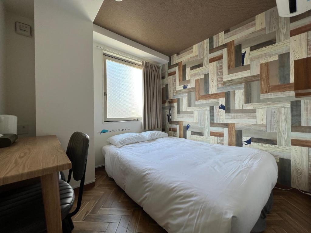 Postel nebo postele na pokoji v ubytování HOTEL WAN OSAKA EBISU