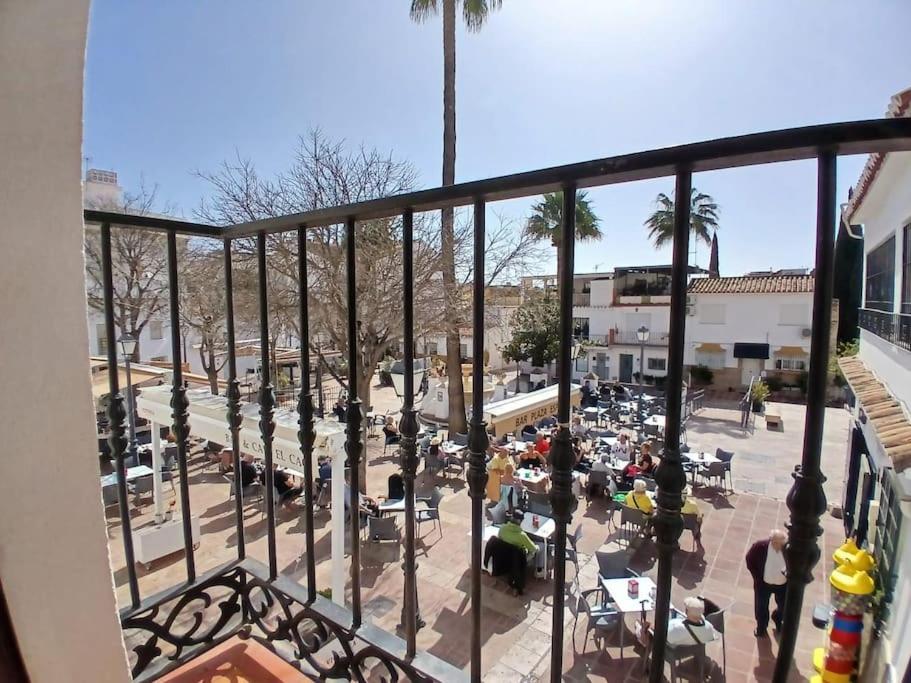 a view from a balcony of a plaza with a crowd of people at weforyou Plza España Benalmádena in Benalmádena