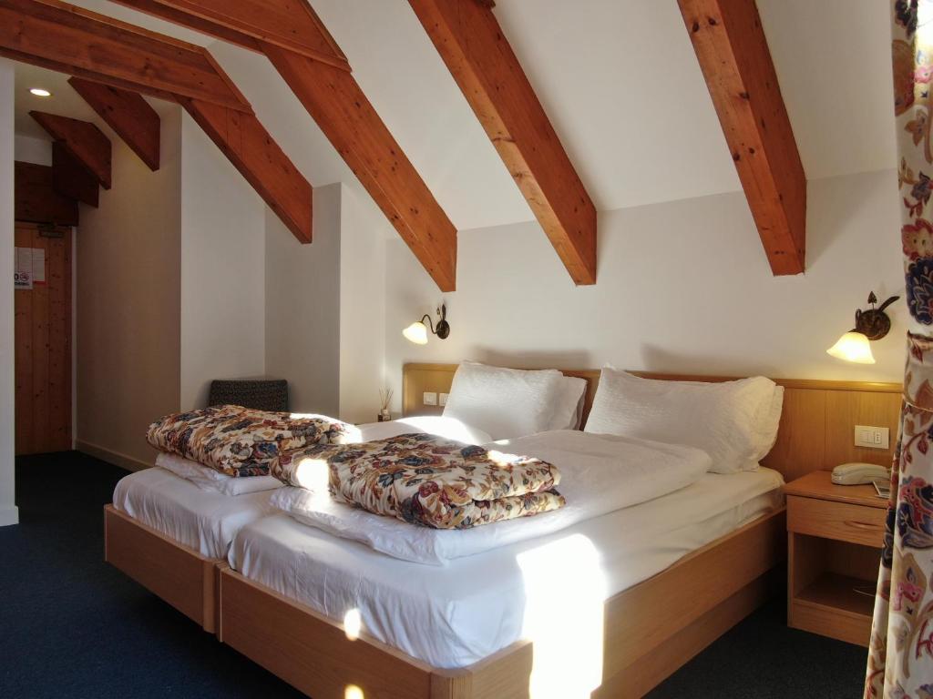 Postel nebo postele na pokoji v ubytování Hotel Fortini