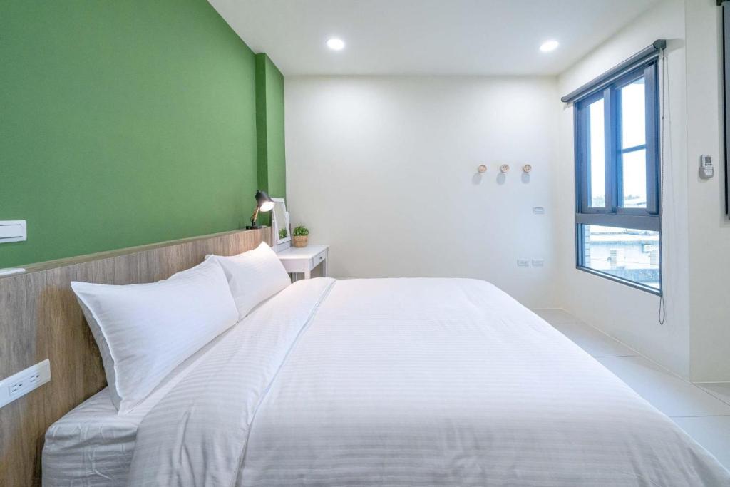 Ένα ή περισσότερα κρεβάτια σε δωμάτιο στο Little House Homestay