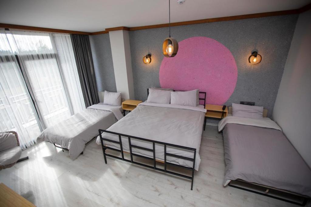 A bed or beds in a room at İspendam Tess Otel