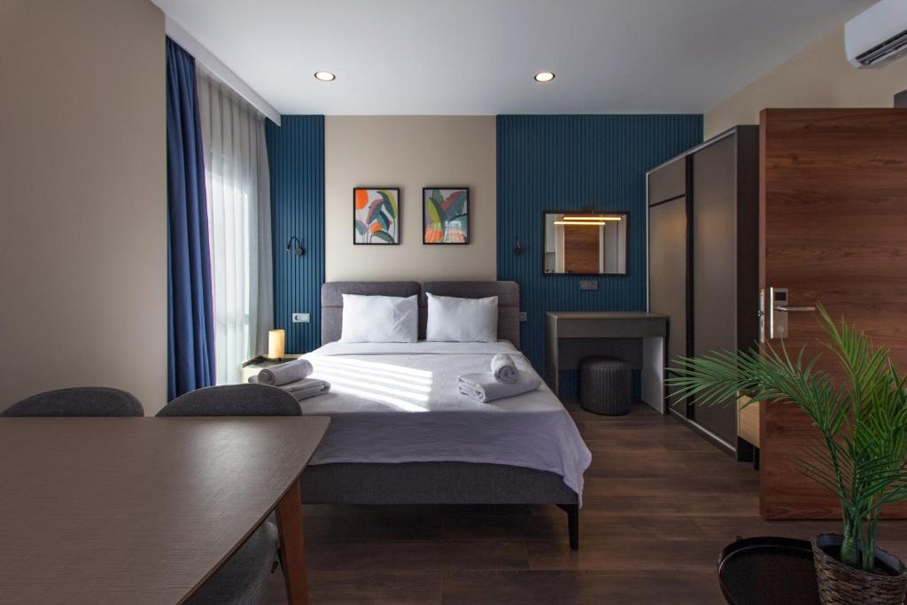 Postel nebo postele na pokoji v ubytování Doqu Suites Hotel