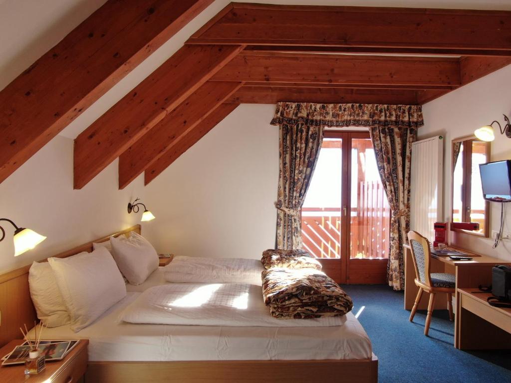 Postel nebo postele na pokoji v ubytování Hotel Fortini
