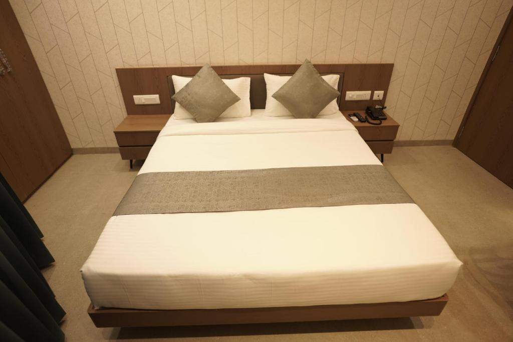 Postel nebo postele na pokoji v ubytování A Square Executive Hotel