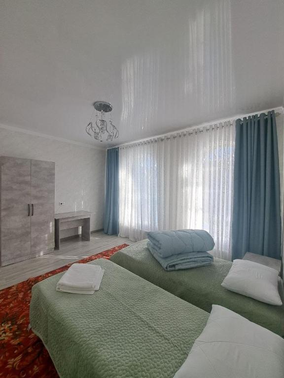 Postel nebo postele na pokoji v ubytování GuestHouse "ERKIN"