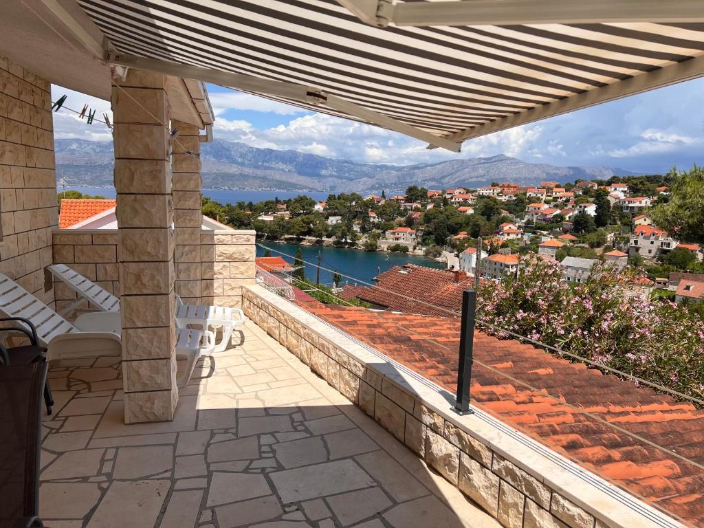 a patio with a view of the water and mountains at Apartment Karla in Splitska