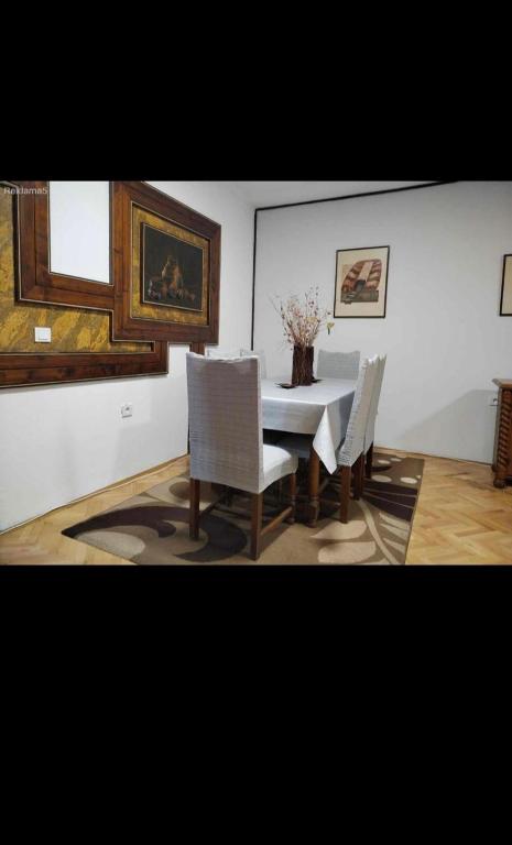a dining room with a white table and chairs at Sashka appartments in Gevgelija