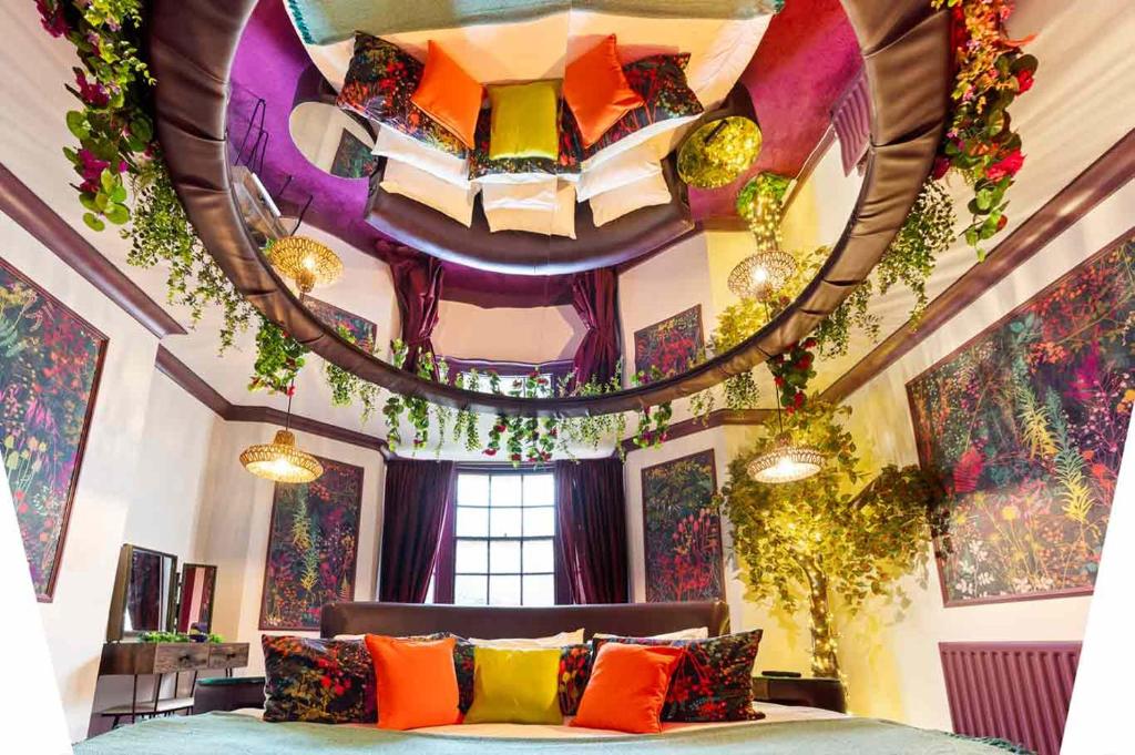 a room with a bed and a ceiling with flowers at Hotel Pelirocco in Brighton & Hove