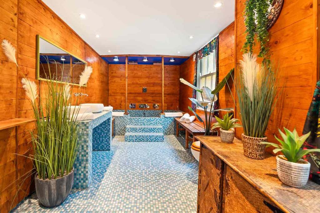 a room with potted plants and a spa at Hotel Pelirocco in Brighton & Hove