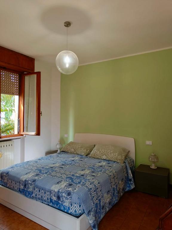 sypialnia z łóżkiem z niebieską kołdrą w obiekcie Casa Lucy w mieście Bardolino
