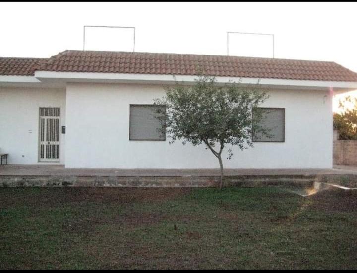 a white house with a tree in front of it at Gemma del salento in Sternatia