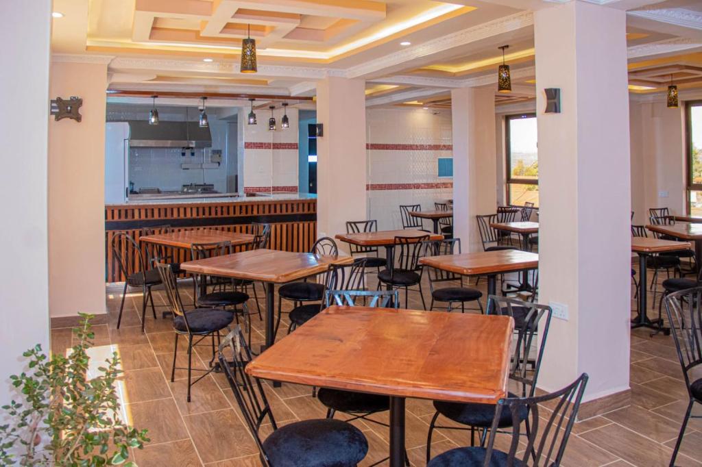a row of tables and chairs in a restaurant at Grand Skyline Hotel in Nakuru