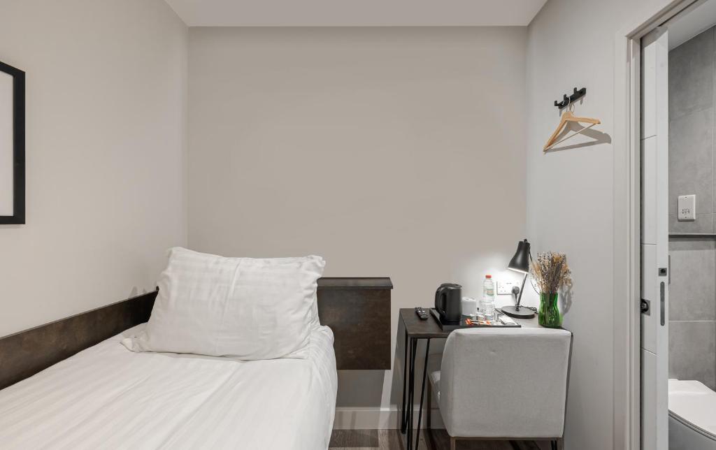 Postel nebo postele na pokoji v ubytování King's Cross Express Inn