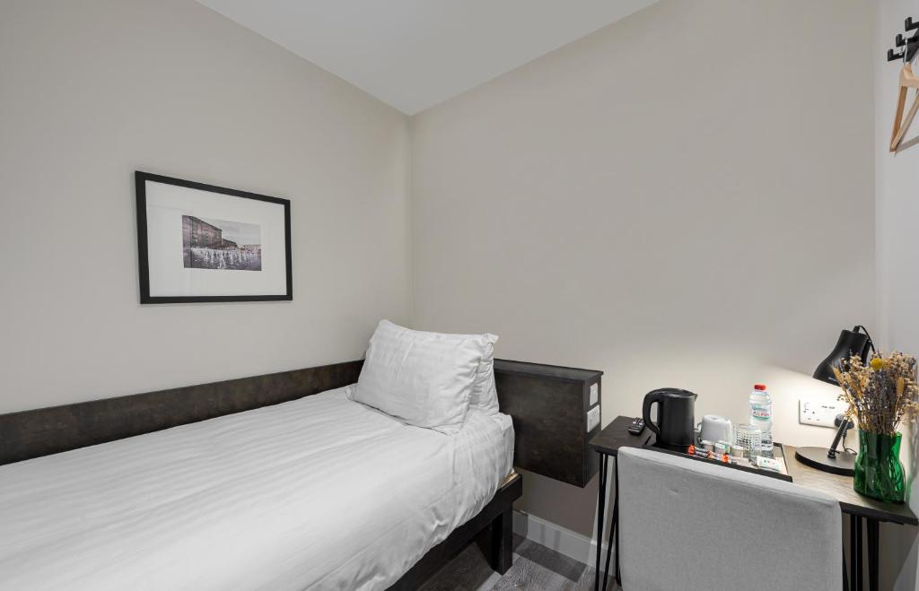 Postel nebo postele na pokoji v ubytování King's Cross Express Inn