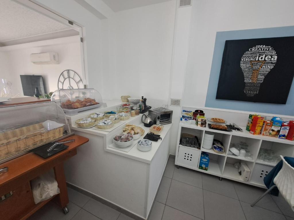 a room with a counter with different types of food at Maniel Beach Hotel in Letojanni
