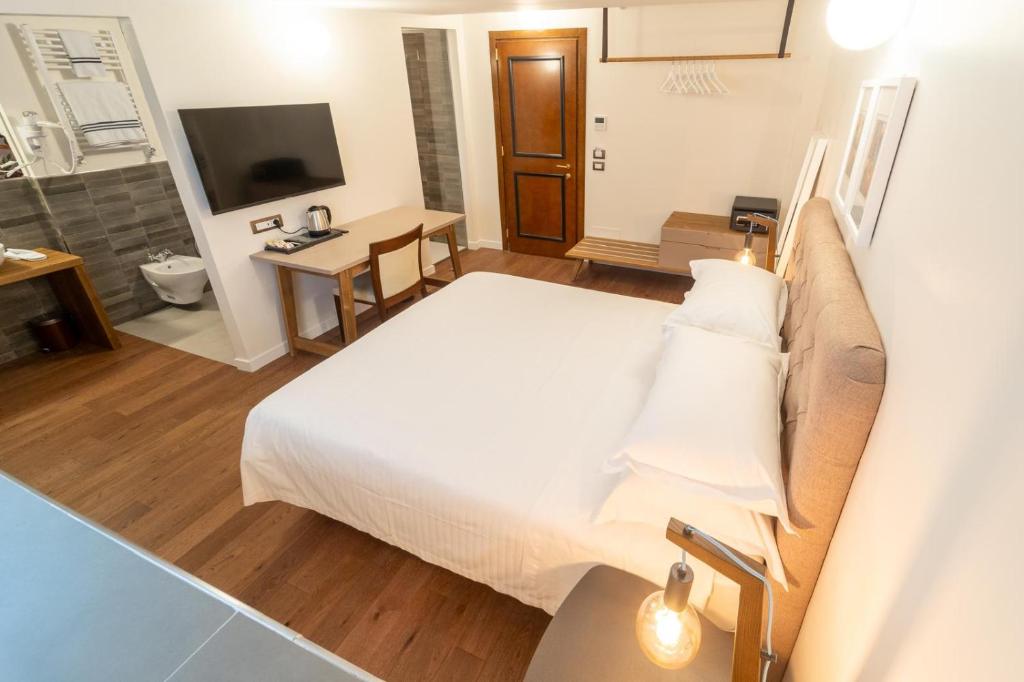 a hotel room with a large bed and a television at Hotel Casal Dell'Angelo in Marigliano