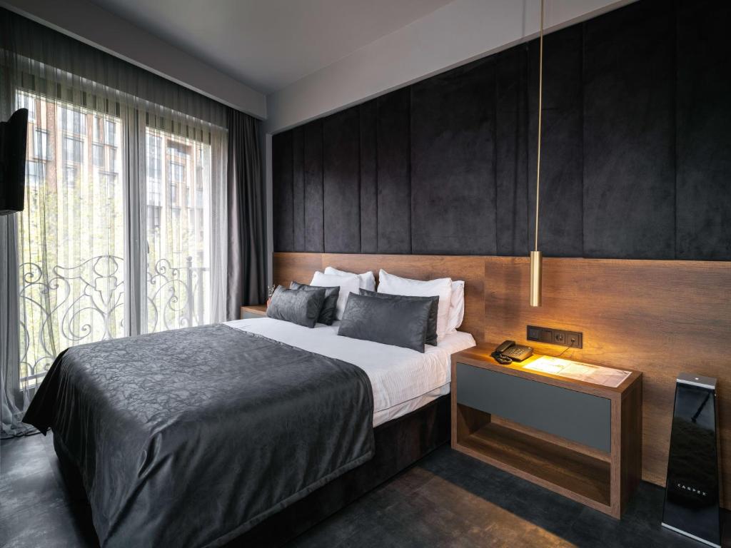 Postel nebo postele na pokoji v ubytování SennaCity Hotel