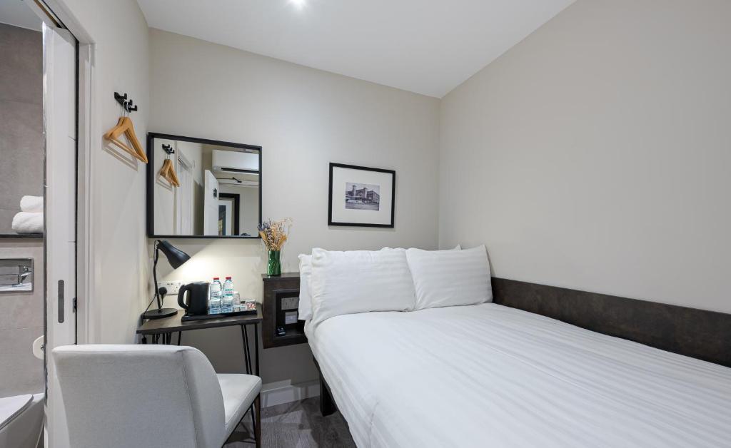 Postel nebo postele na pokoji v ubytování King's Cross Express Inn