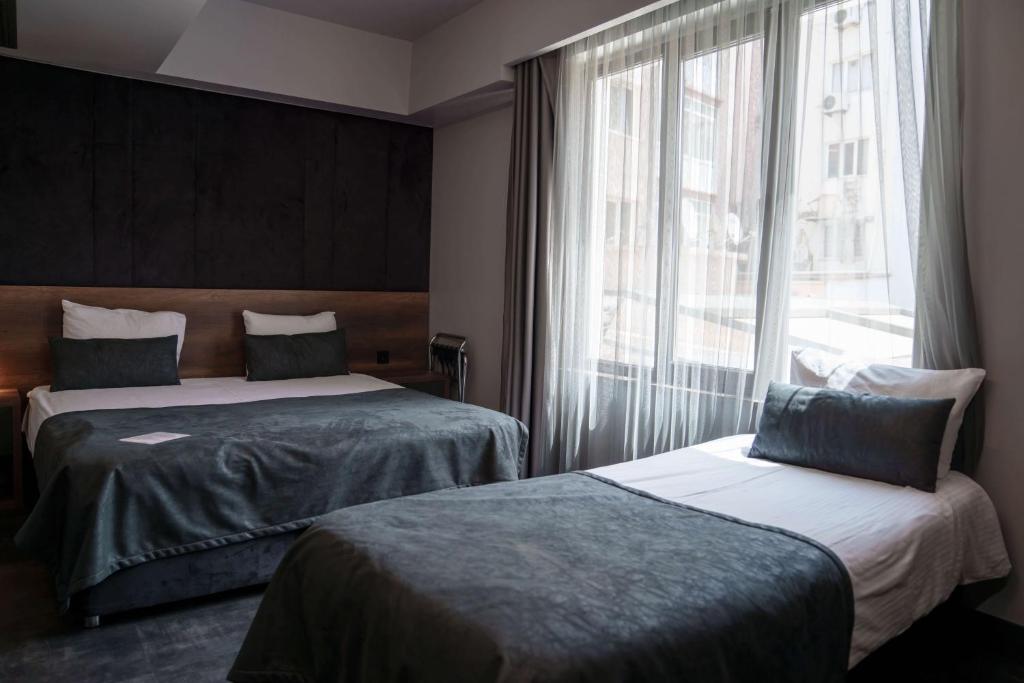 Postel nebo postele na pokoji v ubytování SennaCity Hotel