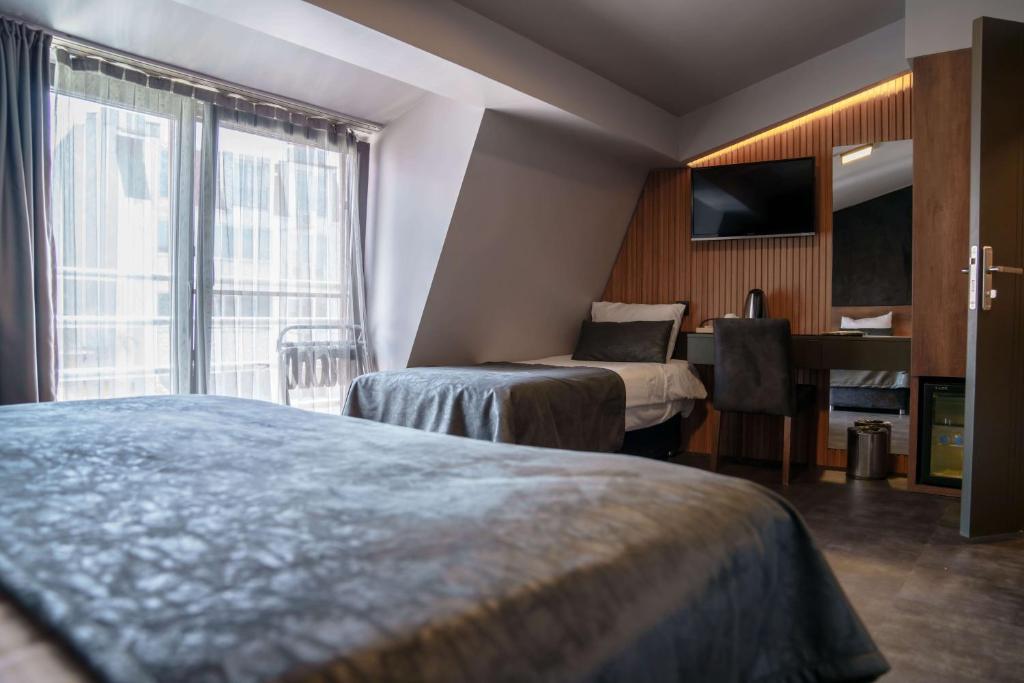 Postel nebo postele na pokoji v ubytování SennaCity Hotel