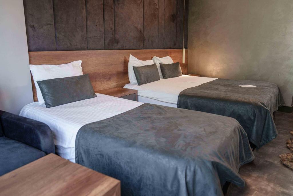 Postel nebo postele na pokoji v ubytování SennaCity Hotel