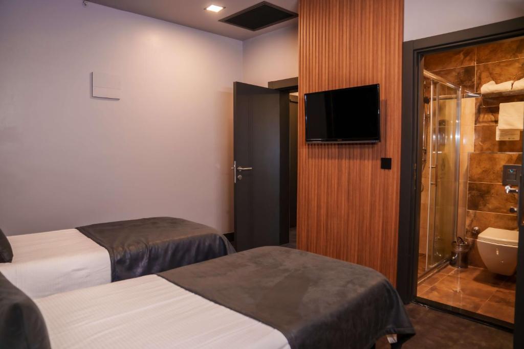 Postel nebo postele na pokoji v ubytování SennaCity Hotel