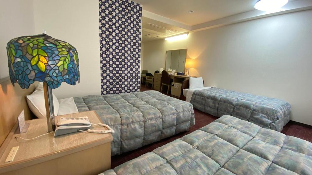 Postel nebo postele na pokoji v ubytování Hotel Luna Park